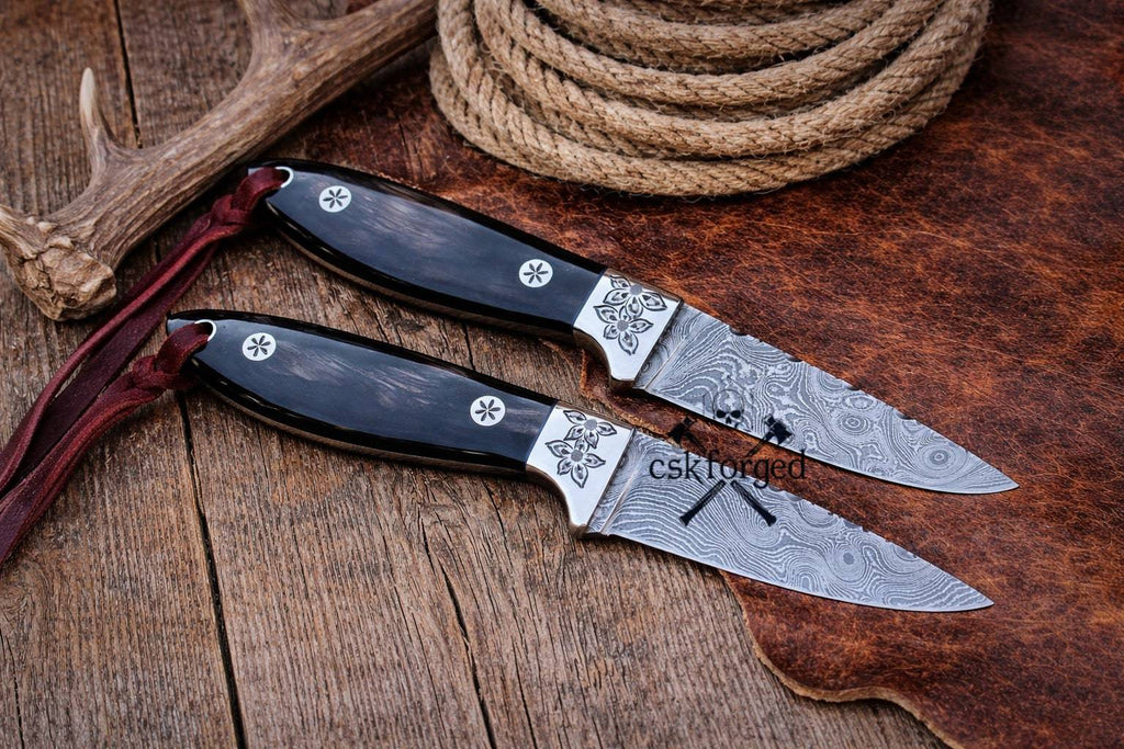 CSKForged Rancher Buckaroo cowboy knife with a 3-inch Damascus blade and belt sheath, ideal for outdoor and ranch use.