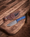 Handmade Damascus hunting knife with blue exotic wood handle by cskforged, featuring a sharp blade and polished wood grip.