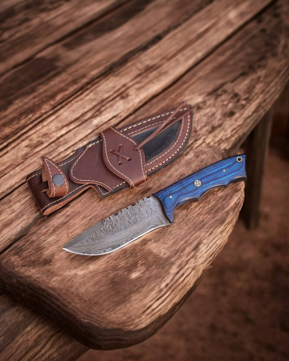 Handmade Damascus hunting knife with blue exotic wood handle by cskforged, featuring a sharp blade and polished wood grip.