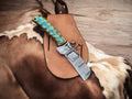 Damascus Bull Cutter EDC knife with jiggle wood handle and belt sheath, crafted by cskforged, featuring a detailed blade and ergonomic grip.