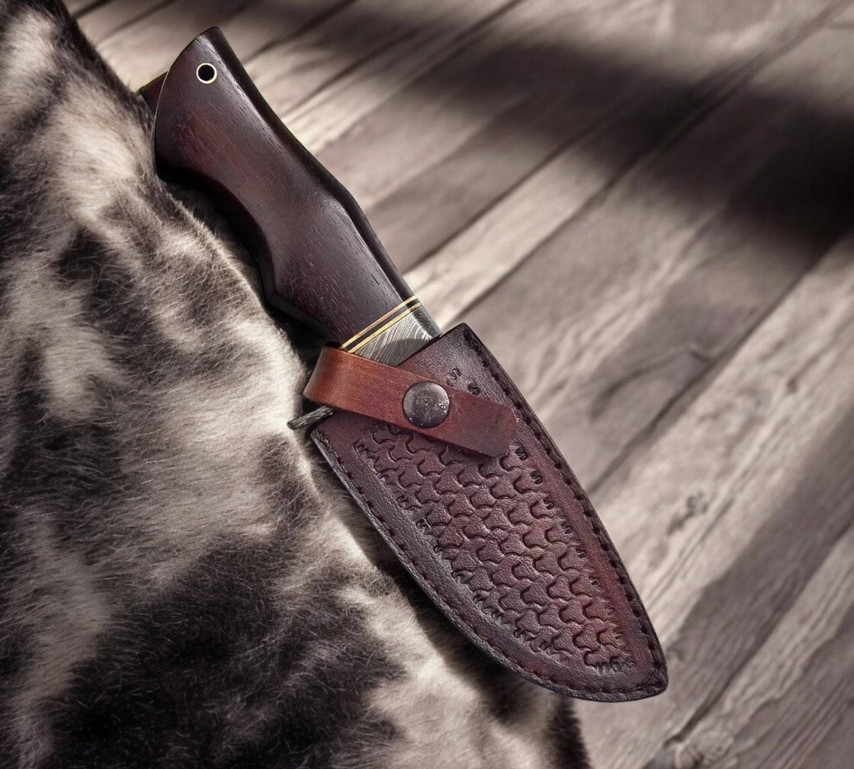 Damascus Feather Bobcat hunting knife by cskforged with a detailed blade and ergonomic handle for outdoor hunting use.