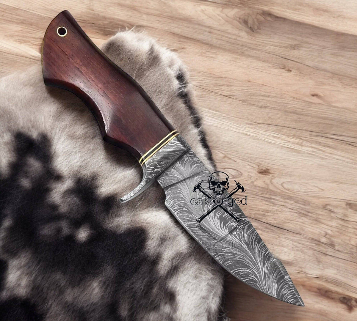 Feather Damascus Bobcat hunting knife by cskforged with a detailed Damascus steel blade and ergonomic handle.