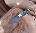 Close-up of cskforged Buckaroo EDC working knife with a 3-inch Damascus blade, showcasing its detailed craftsmanship and handle.
