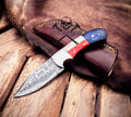 Damascus raindrop blade hunting knife with Texas flag handle by cskforged, showcasing detailed craftsmanship and rugged design.