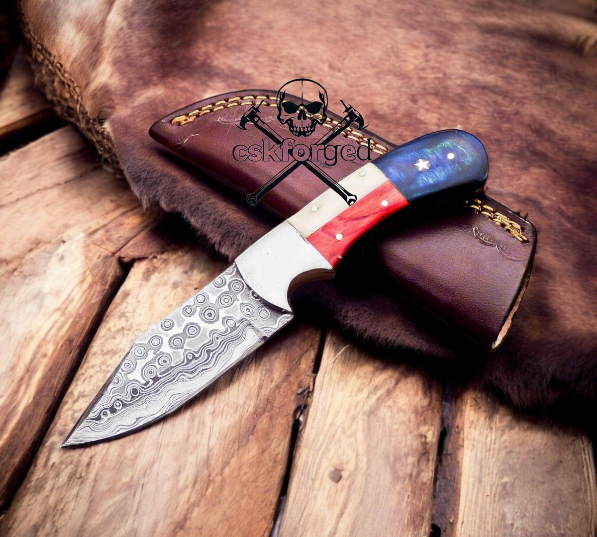 Damascus raindrop blade hunting knife with Texas flag handle by cskforged, showcasing detailed craftsmanship and rugged design.