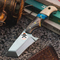 Finger grooved turquoise Tantoo Blade hunting knife by CSK Forged with a textured handle and sharp blade for outdoor use.