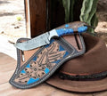 CSKForged cross draw hunting knife with Damascus blade and resin handle, showcasing its sturdy design and craftsmanship.