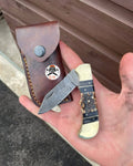 Handmade Damascus Cowboy Pocket Knife with folding Damascus blade by cskforged, featuring a textured handle and intricate craftsmanship.