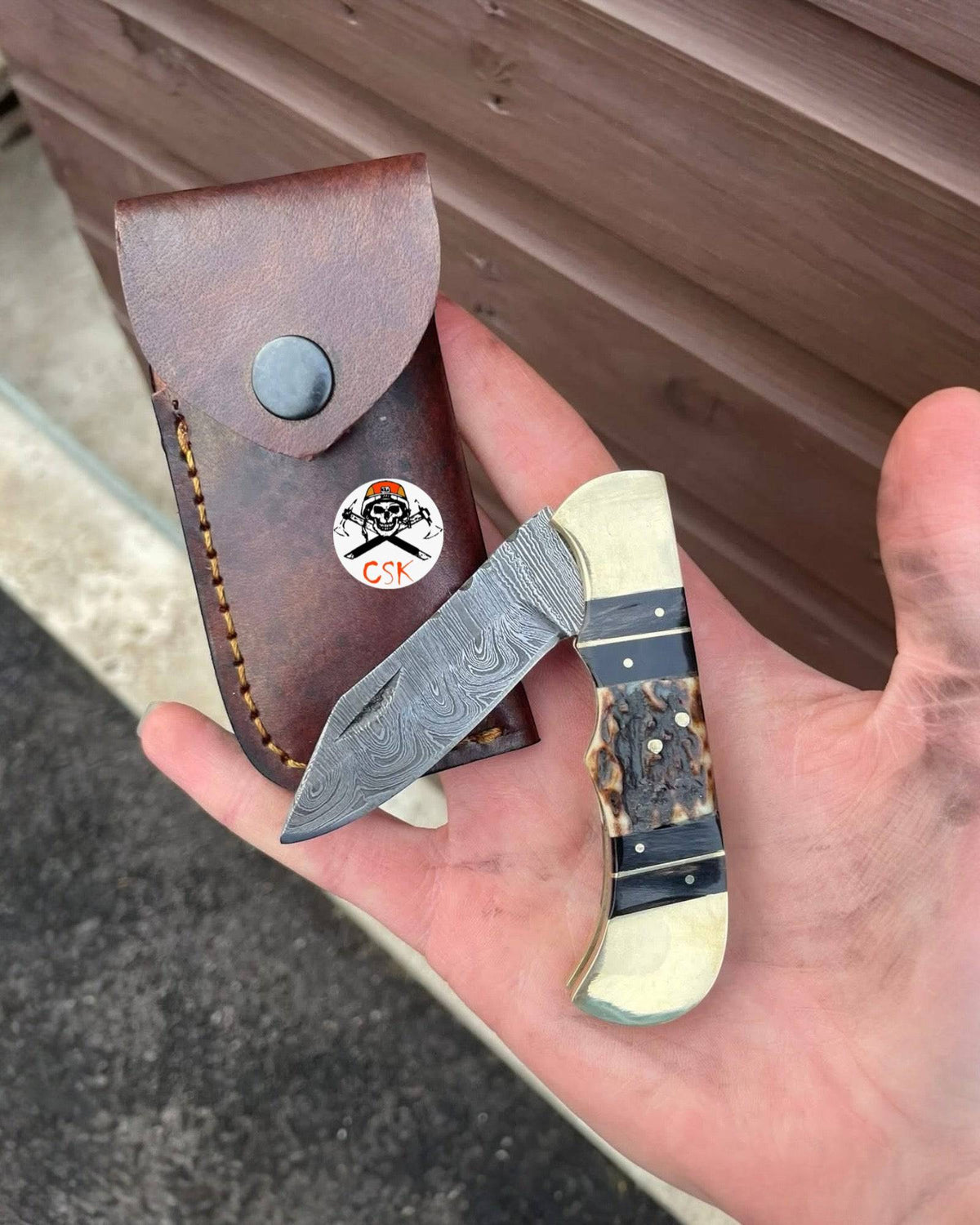 Handmade Damascus Cowboy Pocket Knife with folding Damascus blade by cskforged, featuring a textured handle and intricate craftsmanship.