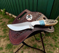 Cross draw hunting sheath knife with rasp steel blade and antler handle, crafted by cskforged in a detailed outdoor setting.