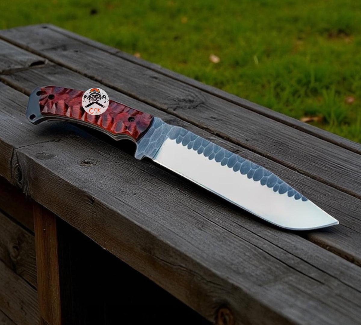 Bushcraft hunting knife with high carbon steel blade by cskforged, featuring a textured handle and leather sheath in outdoor setting.