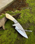 Hand engraved hunting knife by cskforged with custom D2 steel blade and bone handle, showcasing detailed craftsmanship.