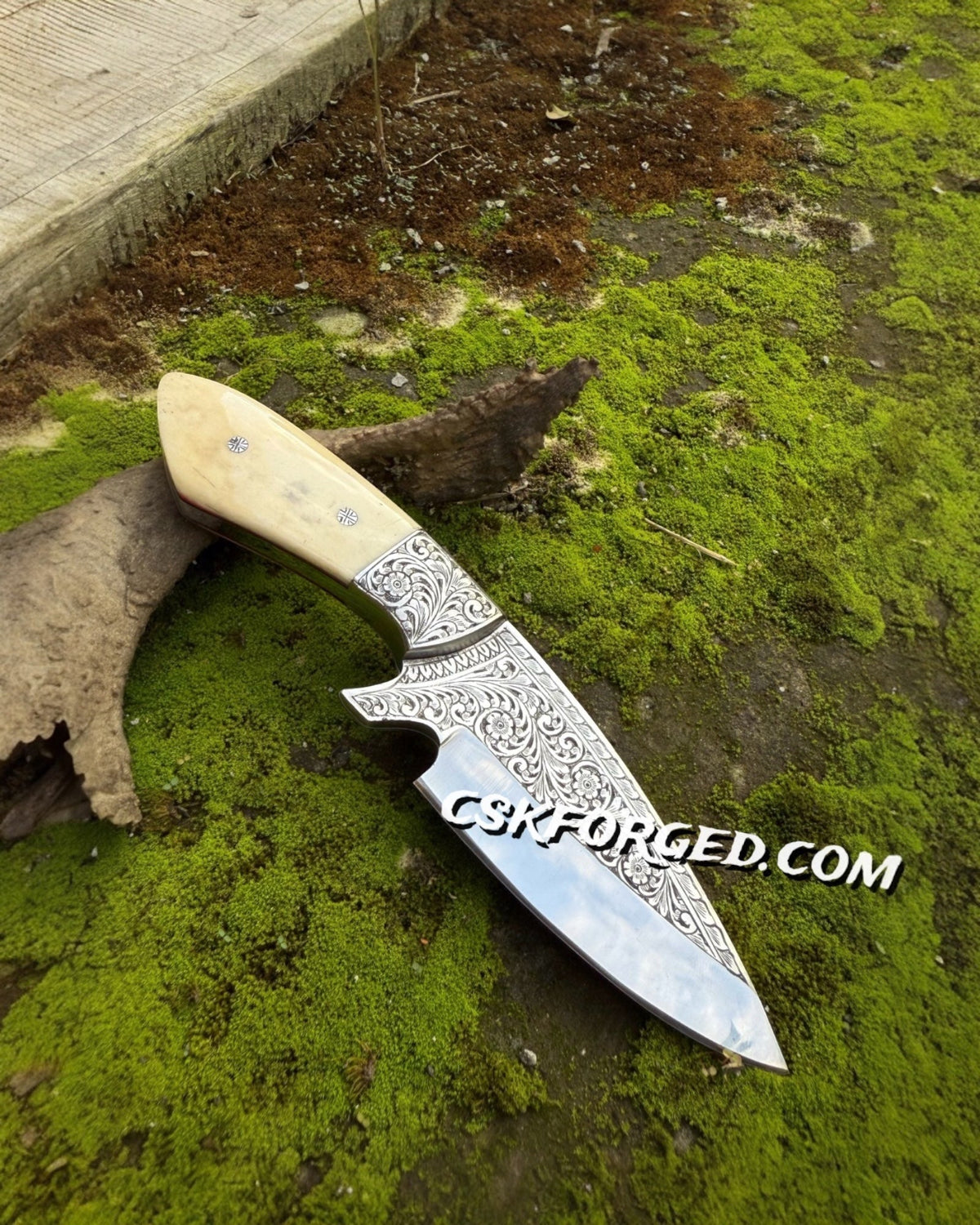Hand engraved hunting knife by cskforged with custom D2 steel blade and bone handle, showcasing detailed craftsmanship.
