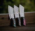 CSKForged Savage Serenity Damascus meat cleaver set with Micarta handles and leather sheath, showcasing the sturdy butcher cleaver and craftsmanship.
