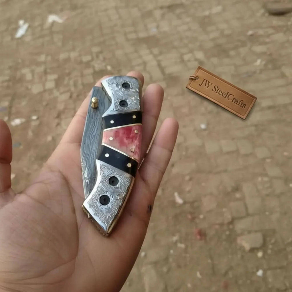 Handmade Damascus folding knife by JW SteelCrafts with engraved bolster, black resin, and colorful bone handle, liner lock EDC pocket knife.