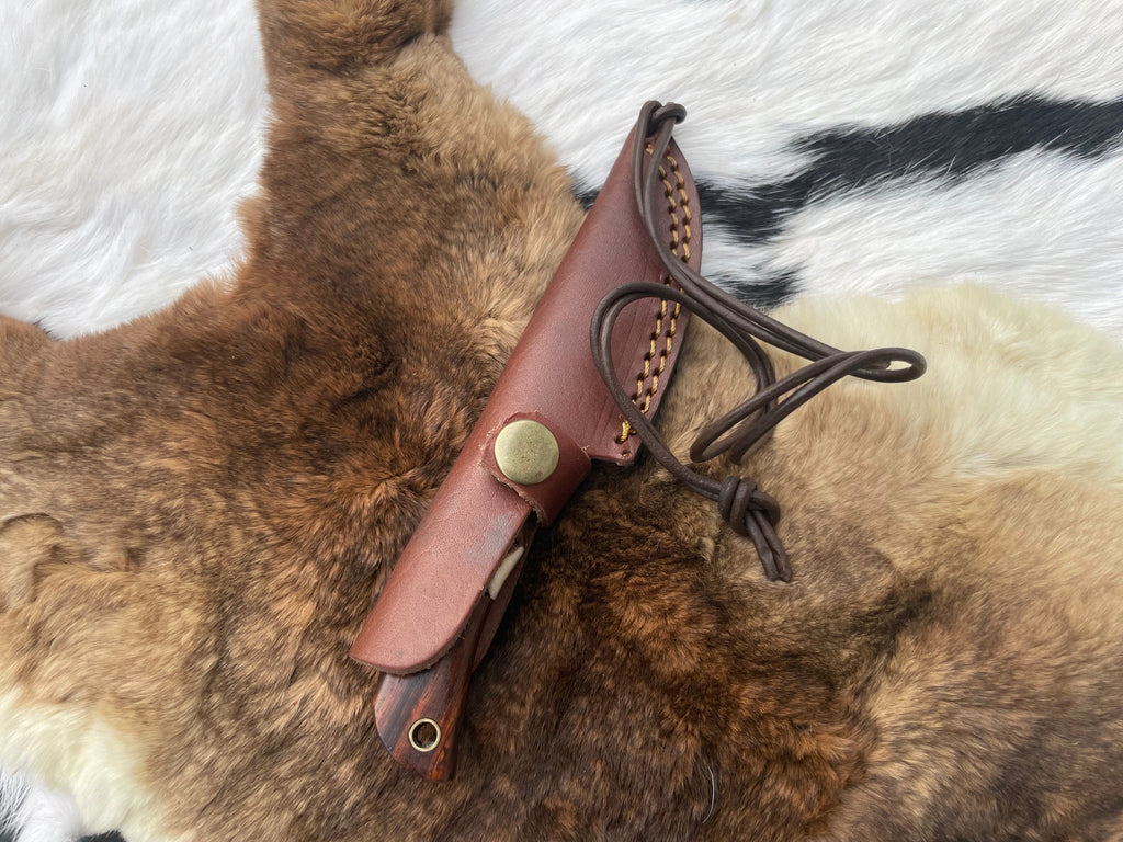 Titan TK-060 Damascus steel skinning knife with rosewood and stag grip, showcasing a sharp blade and handcrafted handle design.
