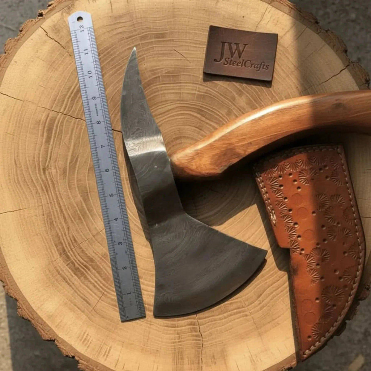 Handmade Damascus bearded spike tomahawk with forged spike poll by JW SteelCrafts, featuring a detailed blade and sturdy handle.