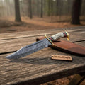 Damascus clip point Bowie knife with handmade coffin handle and stag horn details, crafted by JW SteelCrafts.