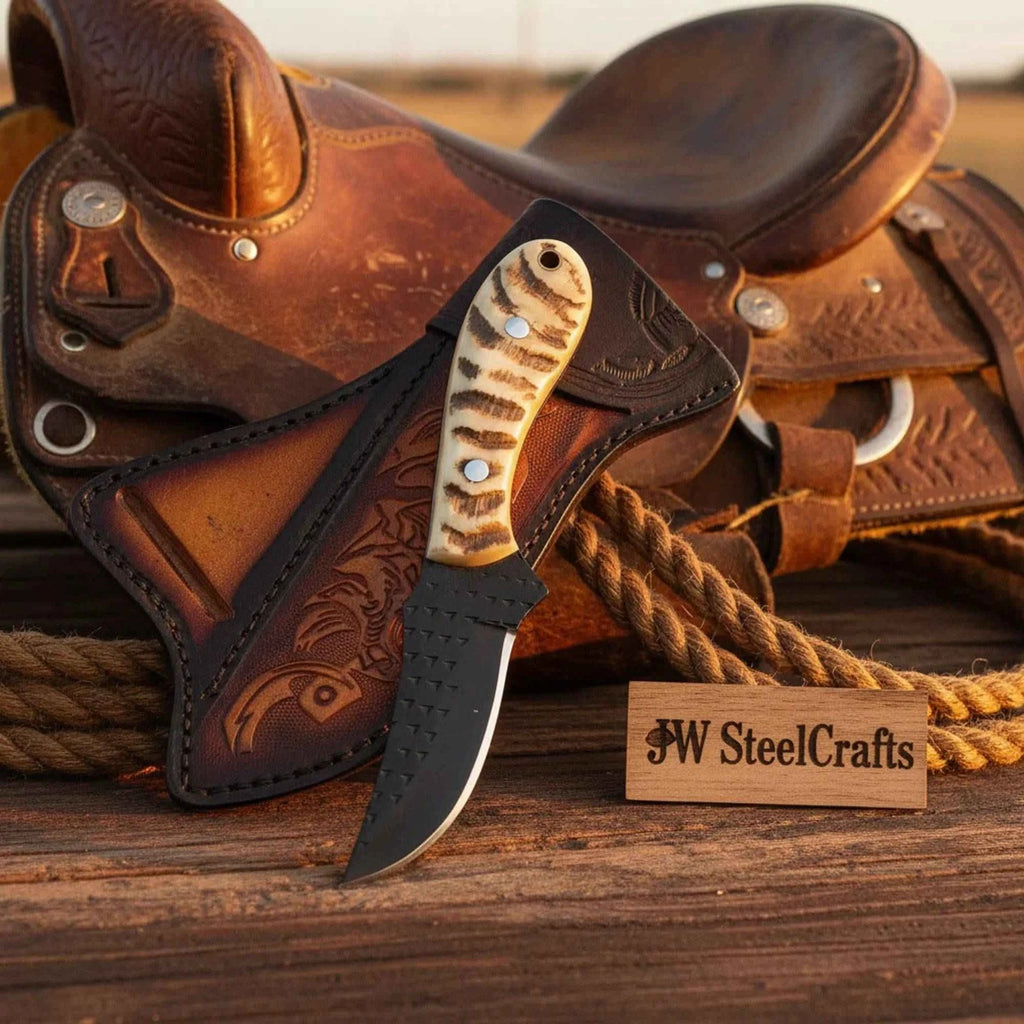 Handmade JW SteelCrafts Ironstag cowboy knife with an 8-inch carbon steel blade and stag horn handle, displayed on a wooden surface.