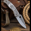 Engraved Scrollwork Folding Knife with Silver Finish and Detailed Blade Etching