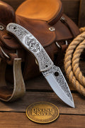 Engraved Scrollwork Folding Knife with Silver Finish and Detailed Blade Etching
