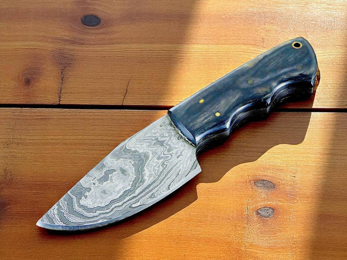 Handmade Damascus skinning knife with a wooden handle, crafted for precision and durability, from Damascus Knife Store.