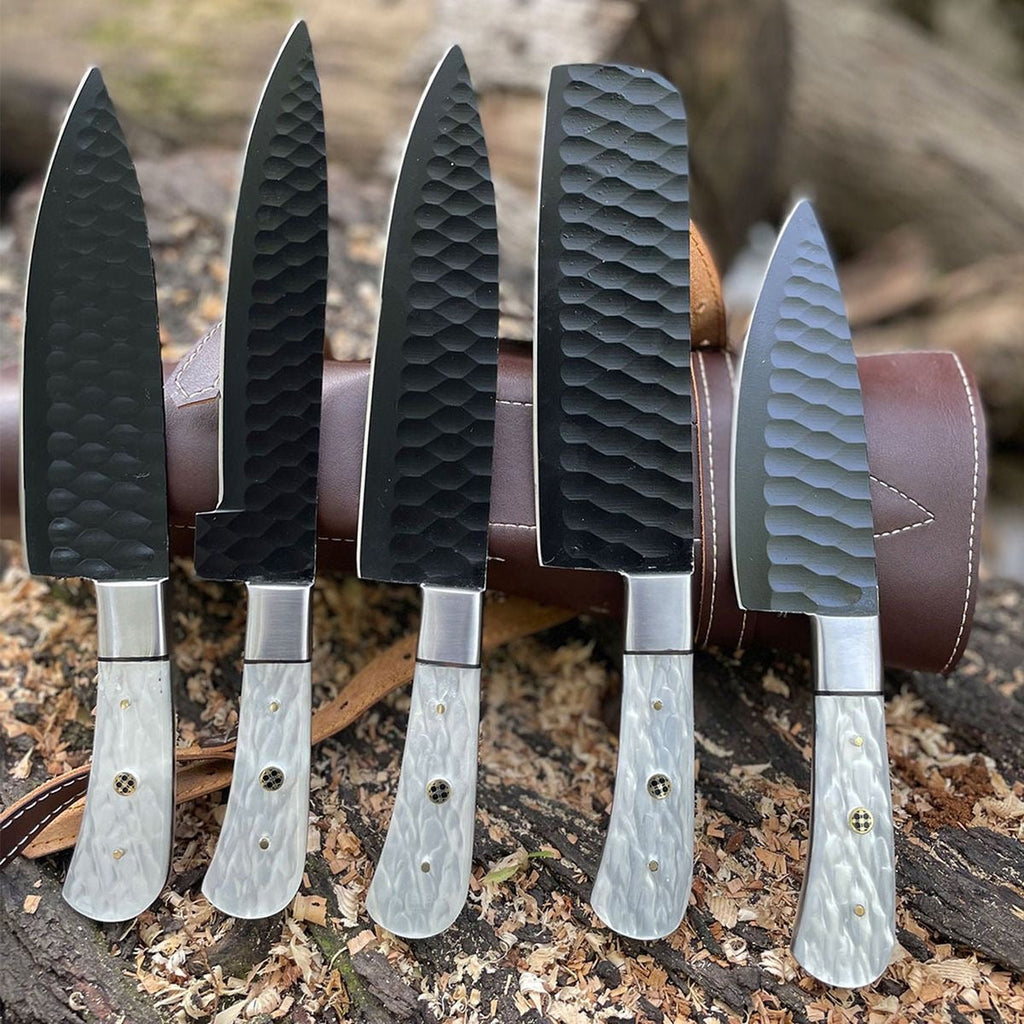 Professional chef knife set with stainless steel blades in a leather case, featuring multiple kitchen knives for culinary use.