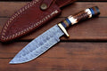 Damascus Knife Store stag horn hunting knife with a 10-inch Damascus blade and decorative stag horn handle.
