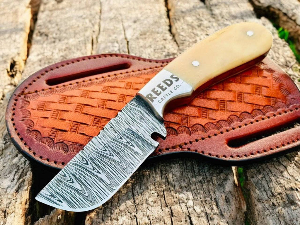 Fixed blade skinning knife with a 3-inch Damascus blade and deer bone handle, ideal for outdoor hunting and skinning tasks.