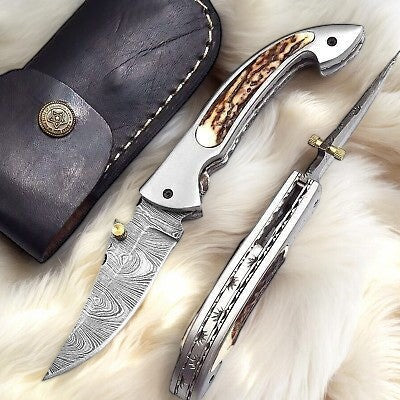 Handmade Damascus pocket knife with a 3-inch blade and stag horn handle, featuring intricate Damascus steel patterns.
