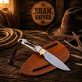 SHAM KNIVES Buckaroo Ranch Skinning Knife with 4-inch D2 steel full tang blade, antler handle, and belt sheath.
