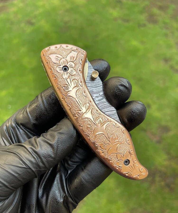 Custom handmade Damascus blade EDC folding pocket knife by cskforged with a textured handle and sleek blade design.