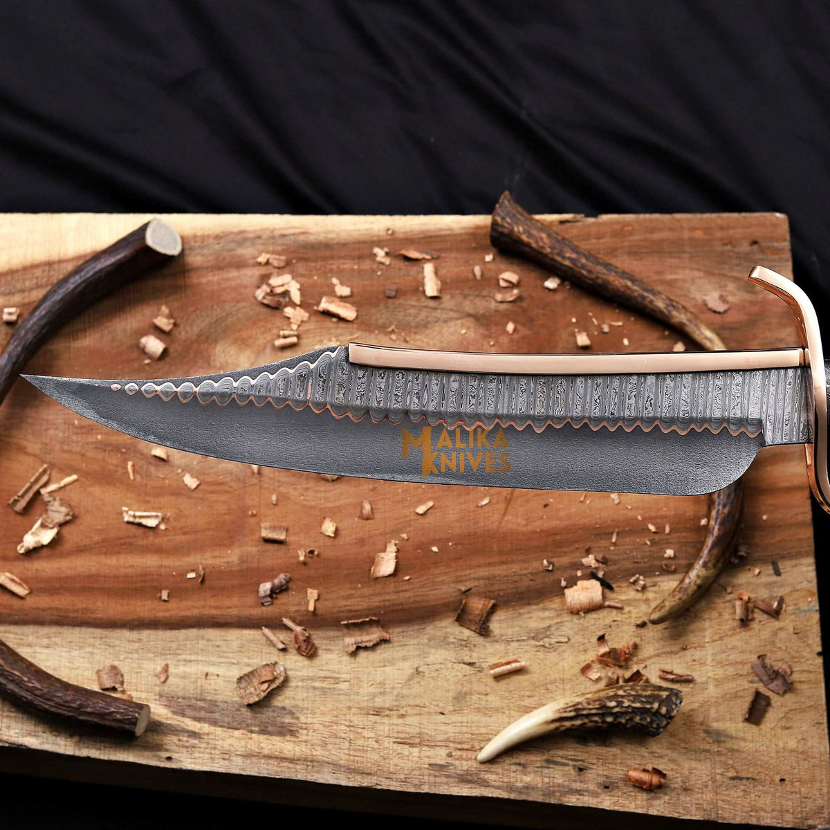Close-up of Copper Damascus Alamo Musso Bowie Knife blade showing intricate pattern and craftsmanship by MALIKA KNIVES.