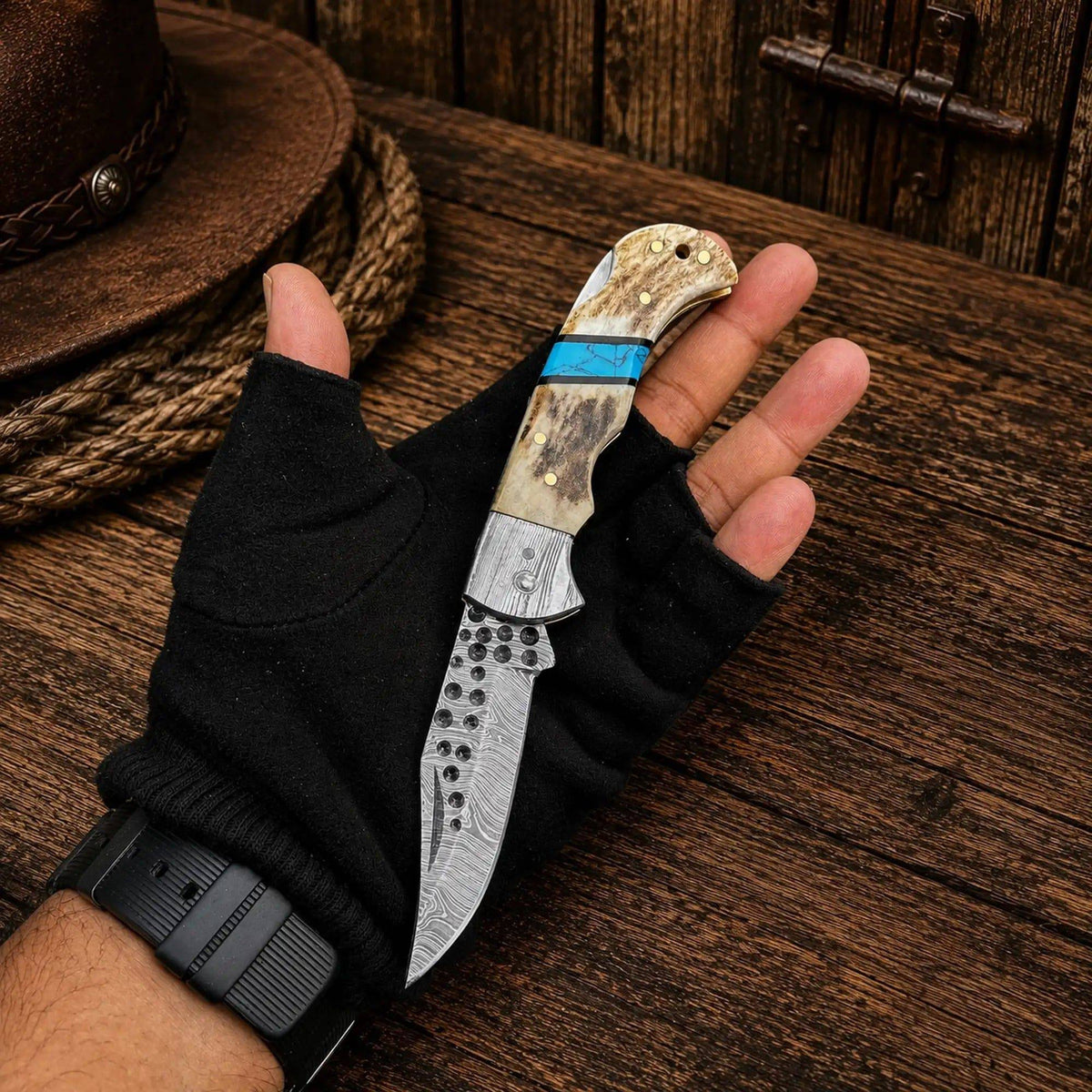 Cowboy Damascus steel folding pocket knife with antler and turquoise handle by cskforged, showcasing a detailed blade and decorative handle.