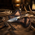 Copper Damascus cowboy field knife with stag horn handle, floral design, and leather belt sheath by SHAM KNIVES.