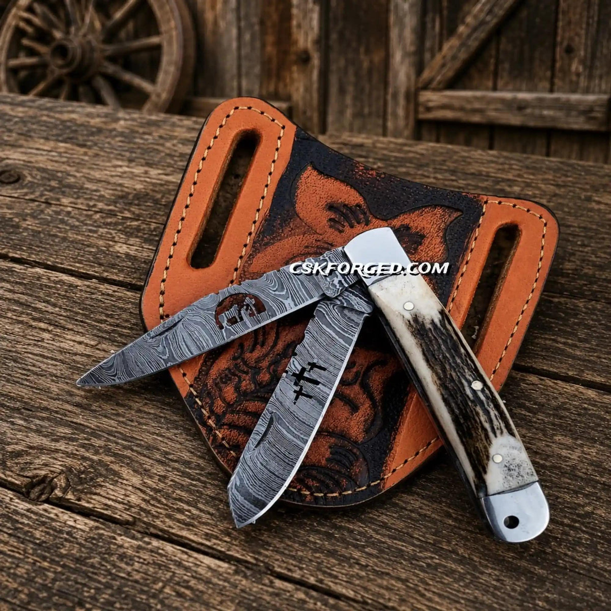 Cowboy folding trapper knife with Damascus double blades and stag handle by CSK Forged, showcasing intricate blade pattern and wood grip.