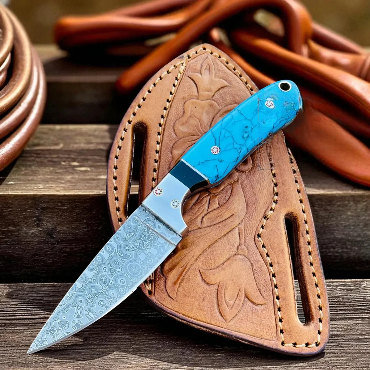 Cowboy hunting knife with Damascus steel blade and marble handle, shown with pancake sheath, made by MALIKA KNIVES.