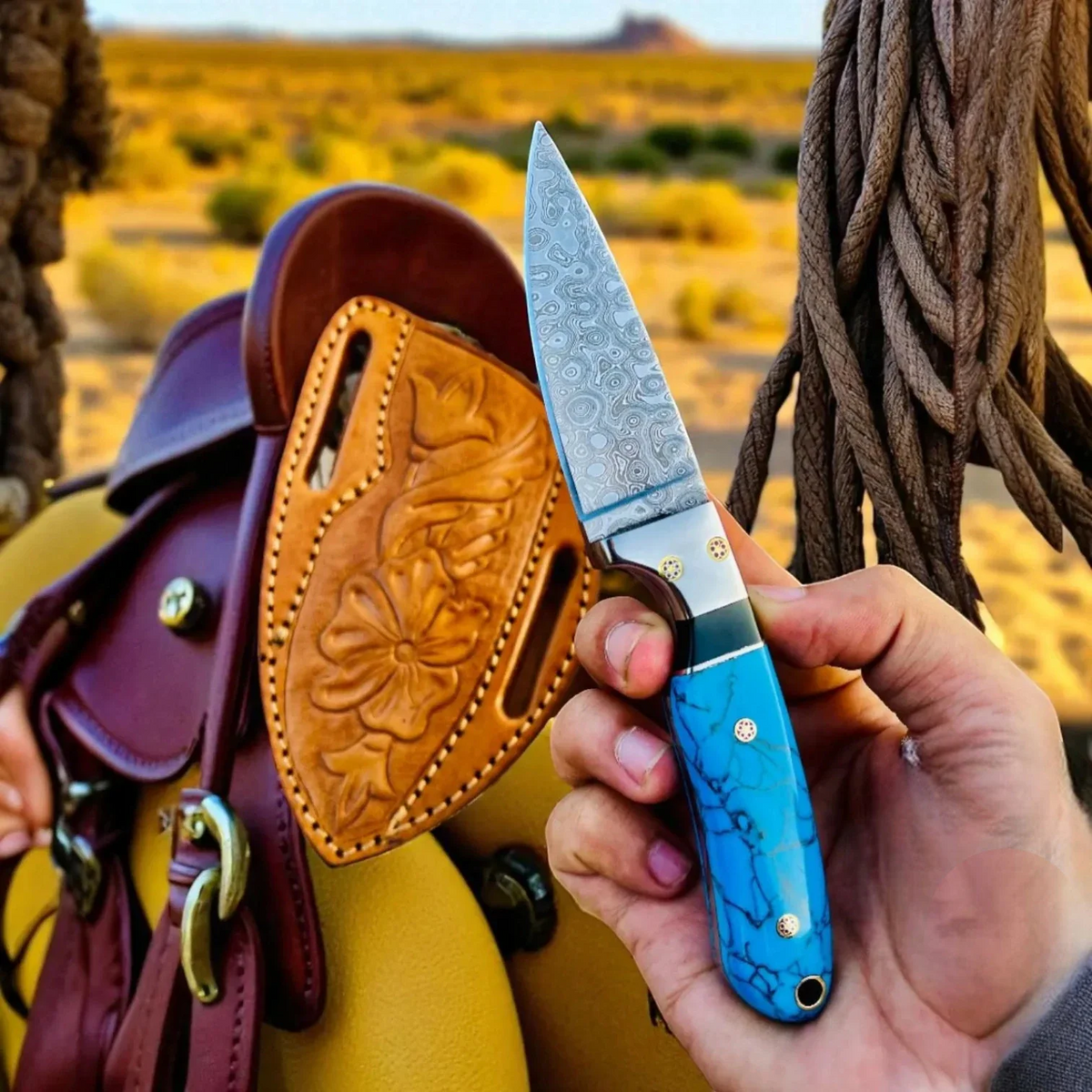 Damascus steel cowboy hunting knife with marble handle and pancake sheath, crafted by MALIKA KNIVES, suitable for outdoor use.