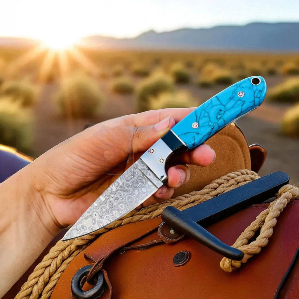 Cowboy hunting knife with Damascus steel blade and marble handle, shown with a pancake sheath, by MALIKA KNIVES.