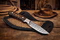 Cowboy hunting sheath knife with 4-inch Damascus steel blade and pinecone handle, designed for rugged outdoor use.