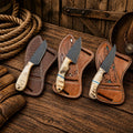 Dutton Ranch Collection SHAM KNIVES cowboy knife with D2 powder-coated blade and Damascus handle in a rugged outdoor setting.