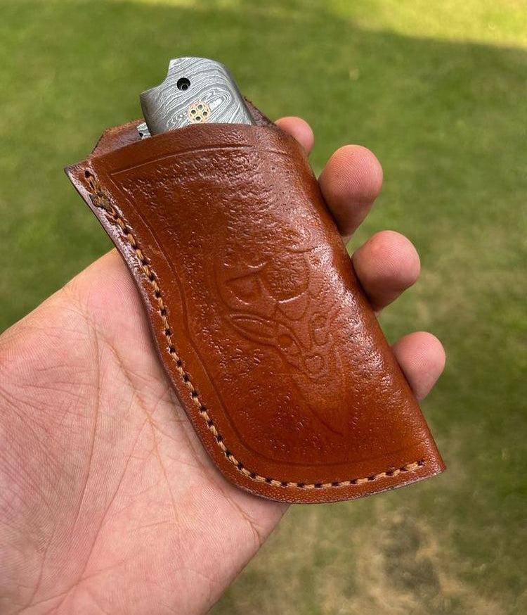 Damascus folding EDC pocket knife by cskforged with a patterned blade and ergonomic handle, suitable for everyday carry.