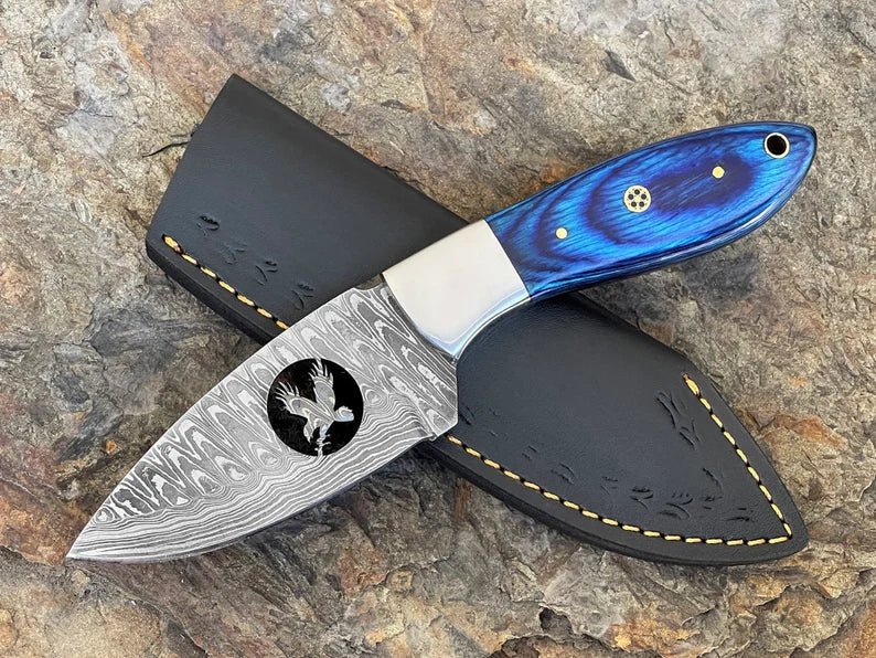 Damascus steel fixed blade hunting knife by SHAM KNIVES with a textured handle and sharp blade, ideal for outdoor hunting tasks.