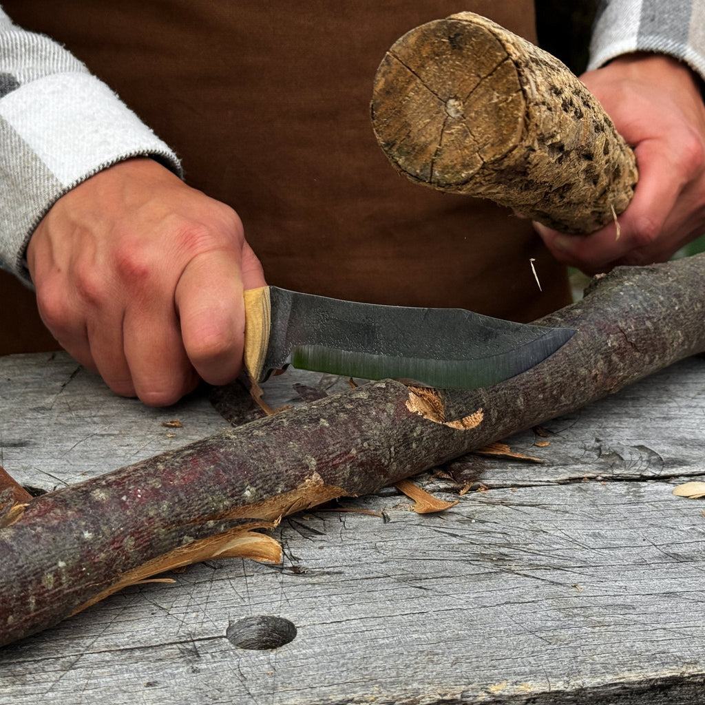 Hand-Forged Bushcraft Knife being used to carve wood | Sharky Forged Steel Tools - Relic & Reel