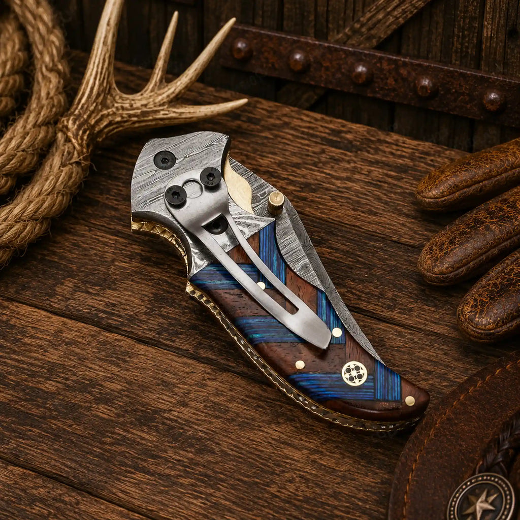 Handmade 7.25-inch Damascus steel Western cowboy folding pocket knife with compact wood handle and leather sheath.