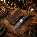 Handmade Damascus folding pocket knife with green Pakka wood handle and back lock, ideal for everyday carry by SHAM KNIVES.