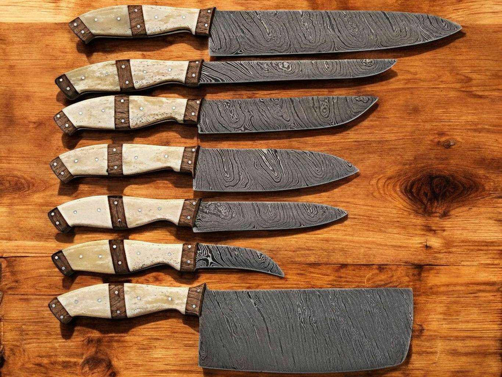 Handmade Damascus kitchen knives set with bone and rosewood handles, featuring sharp blades and intricate Damascus pattern.