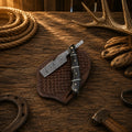 Handmade Damascus steel straight razor with buffalo horn handle by cskforged, showcasing its sharp blade and elegant natural handle.