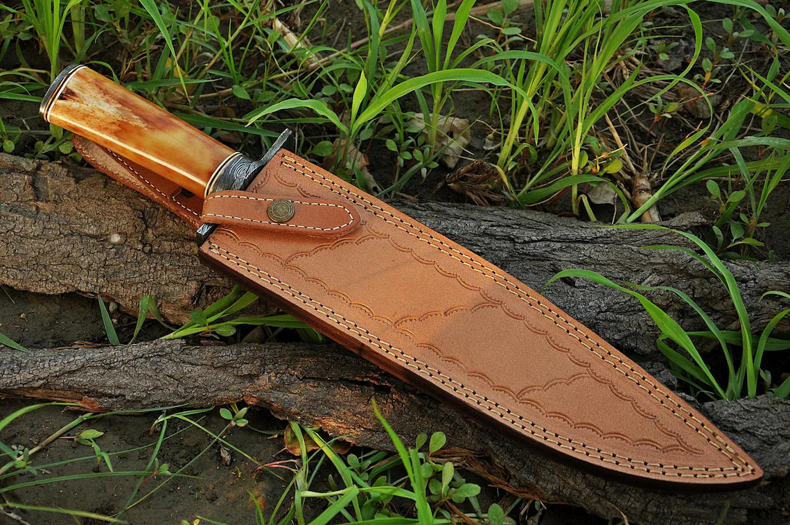 Custom handmade Damascus steel hunting Bowie knife with bone handle, 15-inch blade, Damascus steel guard, and leather sheath.
