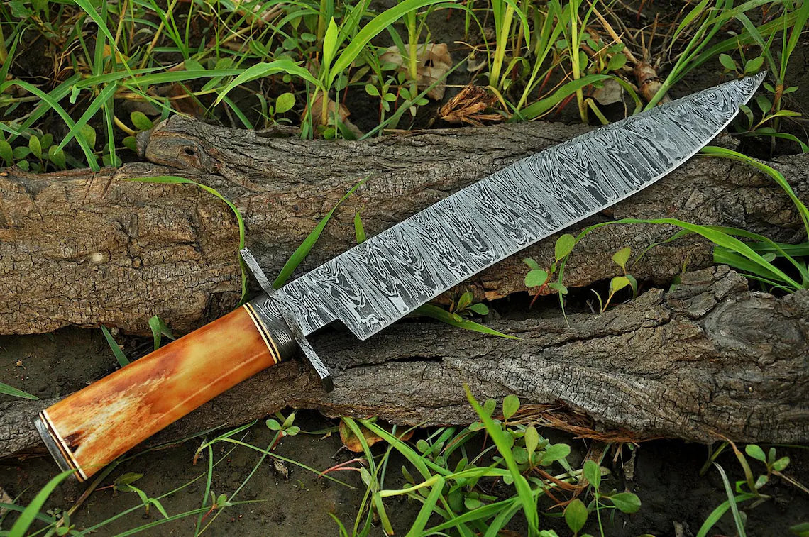 Custom handmade Damascus steel hunting Bowie knife with bone handle, 15-inch blade, steel guard, and leather sheath.